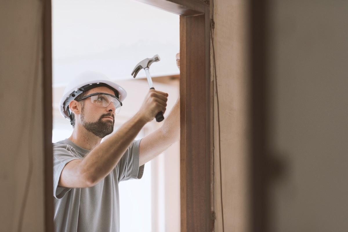 carpenter-installing-a-door-jamb-at-home-LFY5VK6 (1)