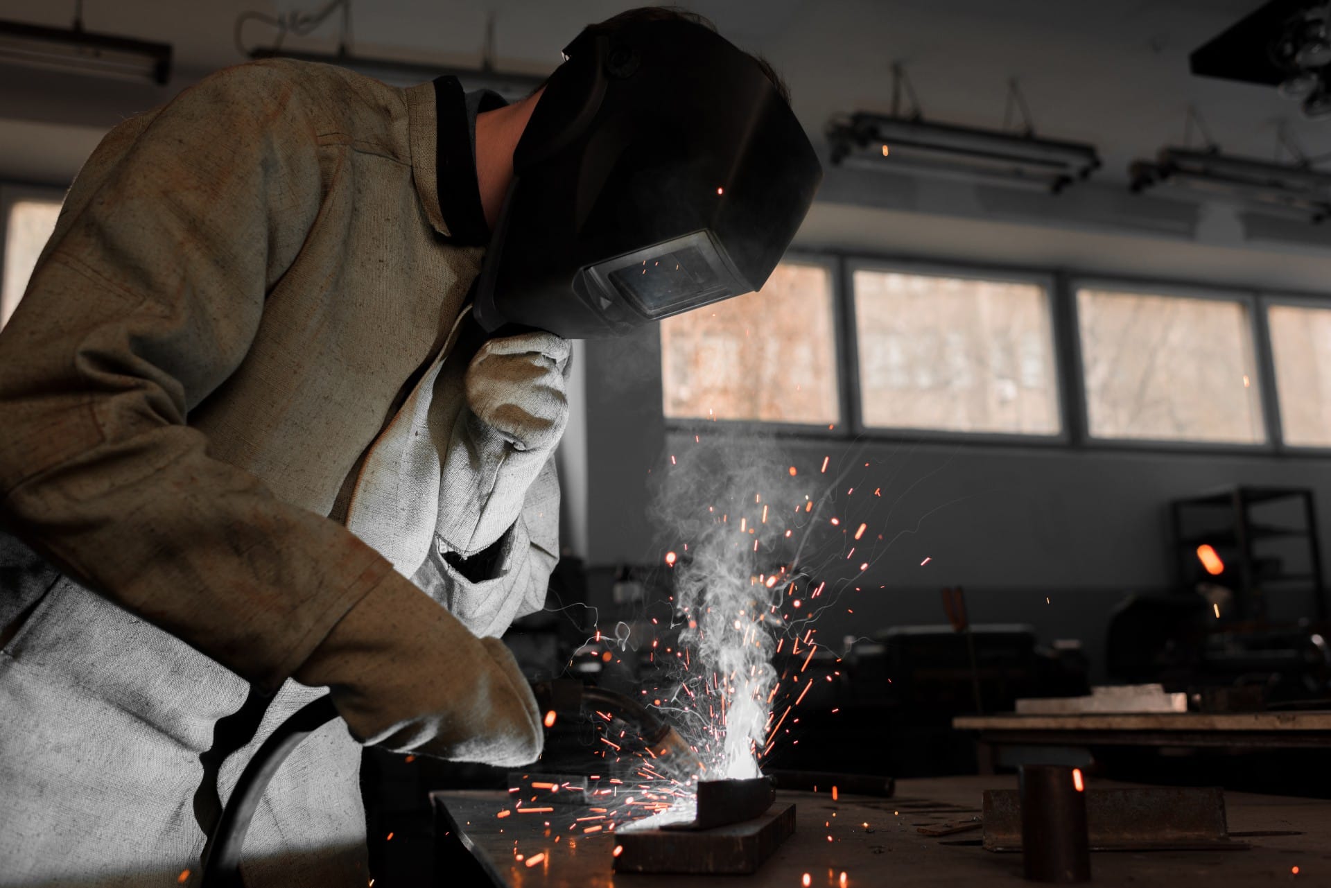 manufacture-worker-welding-metal-with-sparks-at-fa-LRNSRS7 (1)
