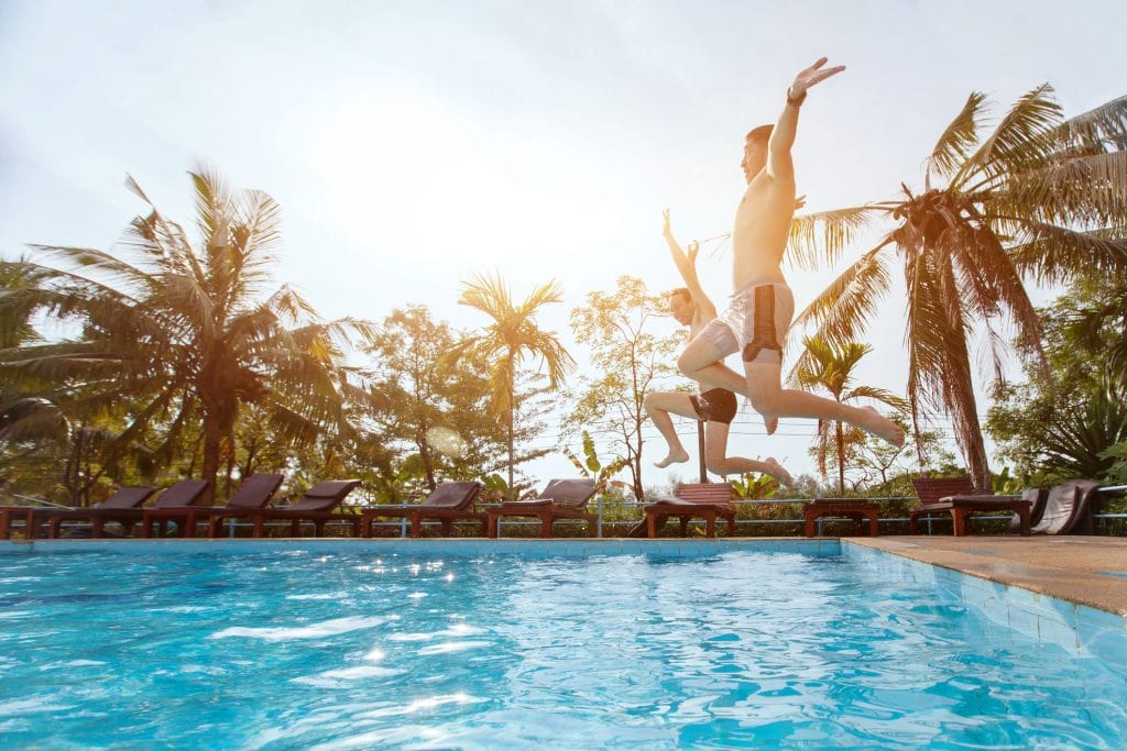 Two guys diving onto pool lead generation